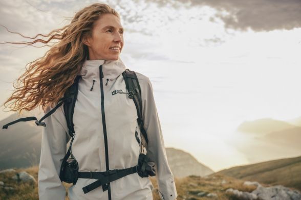 Woman in spring hiking outfits in a mountainous region.