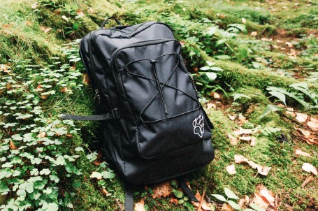 Man with a pack hiking in a verdant, mountainous&nbsp;area.