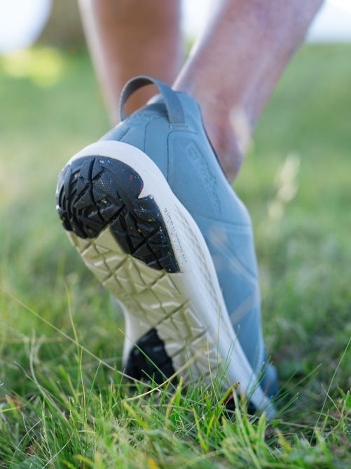 Rear view close-up of a shoe’s sole in the grass