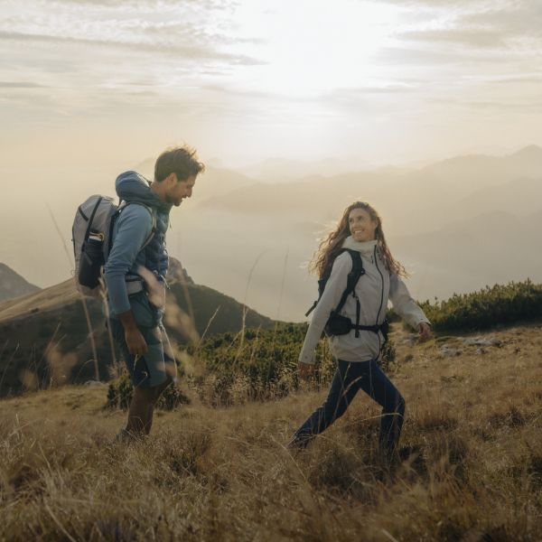 A couple in hiking outfits on a mountain