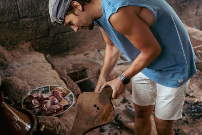 A man using a pair of bellows