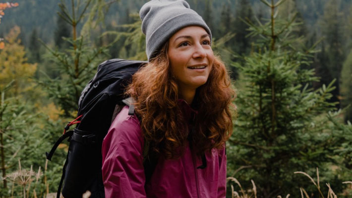 A woman with a daypack hiking